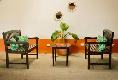 two chairs and a table with a plant on it at Hotel Hacienda del Mar in Carrillo
