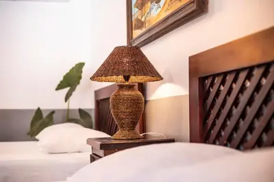 a lamp sitting on a table next to a bed at Hotel Hacienda del Mar in Carrillo