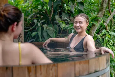a woman in a hot tub with a woman at Rio Chirripo in Rivas