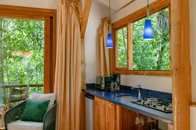 a kitchen with a sink and two windows and a counter at Rio Chirripo in Rivas