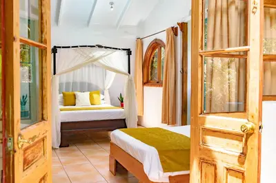 a bedroom with a bed and a bunk bed at Rio Chirripo in Rivas