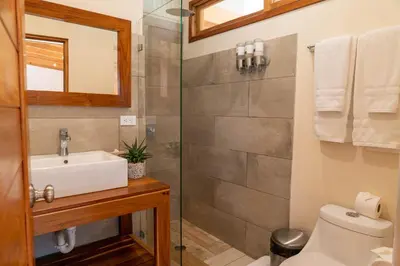 a bathroom with a sink and a shower at Rio Chirripo in Rivas