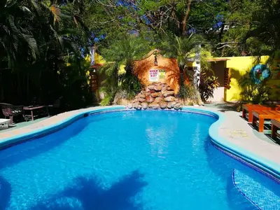a swimming pool in a yard with a house at Villas Verdes in Sámara