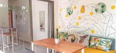 a table in a room with a mural on the wall at Calma Apartments Costa Rica in Mal País