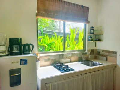 a kitchen with a sink and a window at Calma Apartments Costa Rica in Mal País