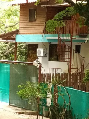a house with a fence in front of it at Burnt Toast Surfcamp in Nosara