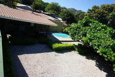 a backyard with a swimming pool and a house at Villa Vilar in Coco