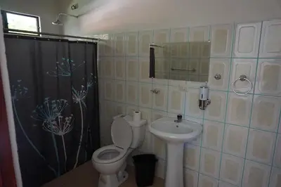 a bathroom with a toilet and a sink at Villa Vilar in Coco