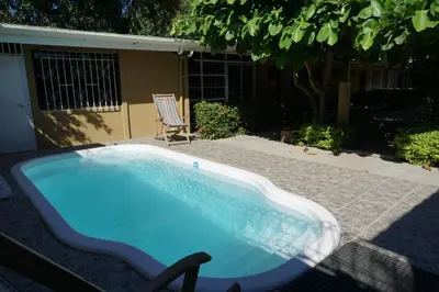 a swimming pool with a chair next to a house at Villa Vilar in Coco