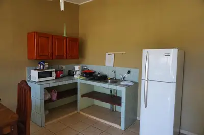 a kitchen with a counter and a white refrigerator at Villa Vilar in Coco