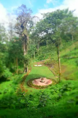 a garden with a fountain in the middle of a field at Reserva Natural Cerro Alto in Empalme