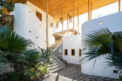 an external view of a building with a staircase at The Nomadic Hotel in Nosara