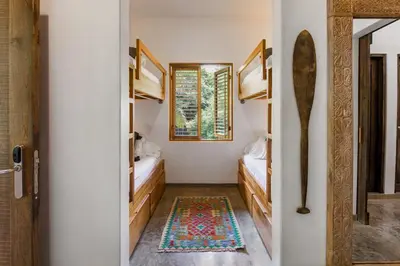 a bathroom with two beds and a mirror at The Nomadic Hotel in Nosara