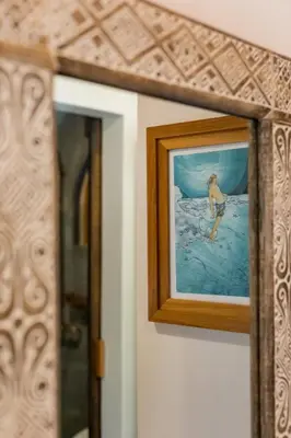 a picture of a woman in the water on a wall at The Nomadic Hotel in Nosara