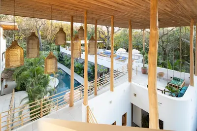 an aerial view of a house with a swimming pool at The Nomadic Hotel in Nosara