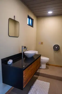 a bathroom with a sink and a toilet at Hotel y Cabinas del Trópico in Guápiles