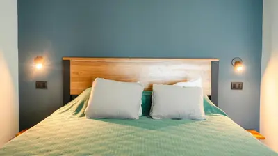 a bedroom with a bed with two white pillows at Hotel Buenos Aires in Santa Teresa Beach