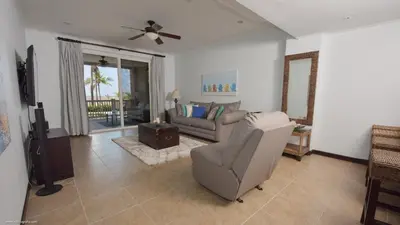 a living room with a couch and a chair at The Palms Jaco in Jacó