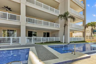 a large building with a swimming pool and a resort at The Palms Jaco in Jacó