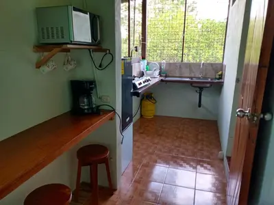 a small kitchen with a sink and a microwave at Posada Rural Río Celeste in Rio Celeste