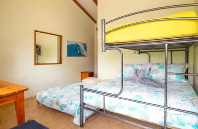 a bedroom with a bunk bed and a table at Hotel Diversion Tropical in Brasilito