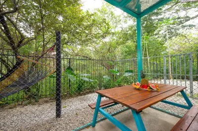 a wooden table with a bowl of fruit on a fence at Hotel Diversion Tropical in Brasilito