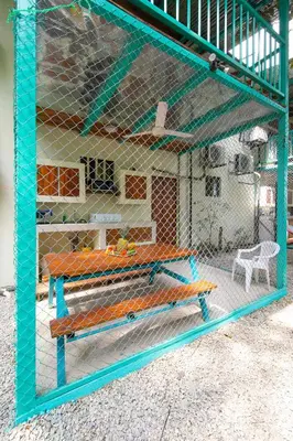 a cage with a bench inside of it at Hotel Diversion Tropical in Brasilito