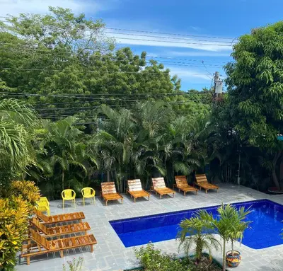 a group of chairs and a swimming pool at Hotel Diversion Tropical in Brasilito