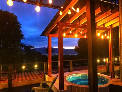 a swimming pool in a pavilion with lights on it at Vistas del Conde in Heredia