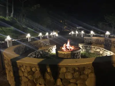 a fire pit with candles and lights in it at Vistas del Conde in Heredia