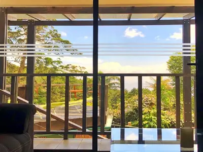 a view from the living room of a house with a large window at Vistas del Conde in Heredia