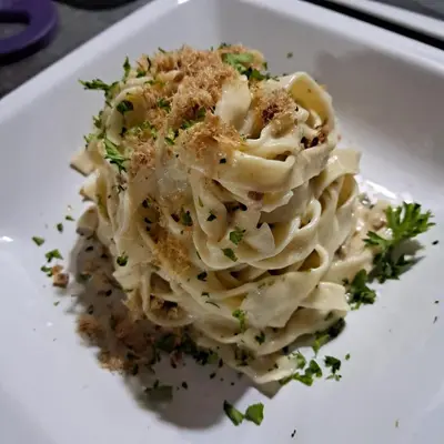 a plate of pasta on a white plate at Dolce Uvita in Bahia