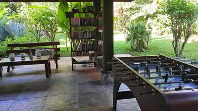 a room with a book shelf and a chess board at Dolce Uvita in Bahia