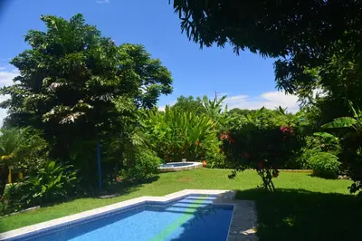 a swimming pool in the yard of a house at Dolce Uvita in Bahia