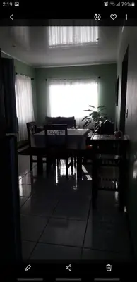 a dining room with a table and chairs and a window at Casa la Fortuna 1 in Fortuna
