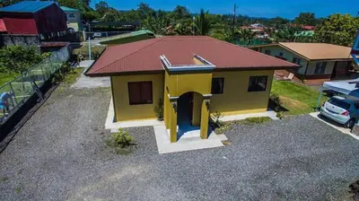 a small yellow house with a red roof at Casa la Fortuna 1 in Fortuna