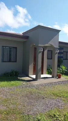 a small house with a driveway in front of it at Casa la Fortuna 1 in Fortuna