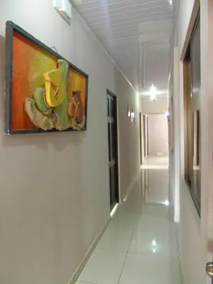 a hallway with a painting of bananas on the wall at Hotel El Descanso in San José