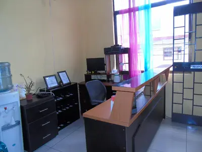 an office with a desk and a chair in a room at Hotel El Descanso in San José