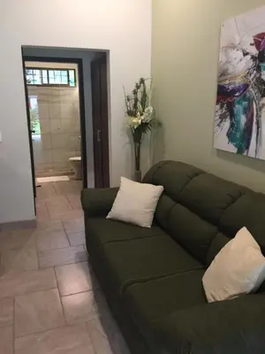a living room with a couch at Guest House in Playa Flamingo