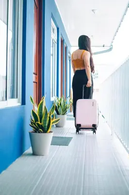a woman in an office with a suitcase at Hotel Alicia in Fortuna