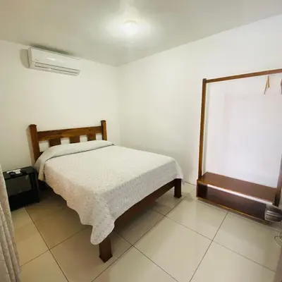 a small bedroom with a bed and a window at Hotel Alicia in Fortuna