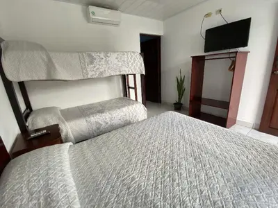 a bedroom with a bed and a flat screen tv at Hotel Alicia in Fortuna