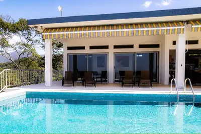a house with a swimming pool in front of it at Casa Laureles in Bejuco