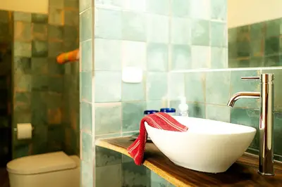 a bathroom with a white sink and a toilet at Casa Laureles in Bejuco