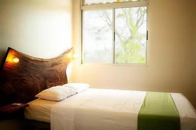 a bedroom with a bed with a window at Casa Laureles in Bejuco