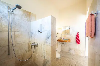 a bathroom with a shower and a toilet at Casa Laureles in Bejuco