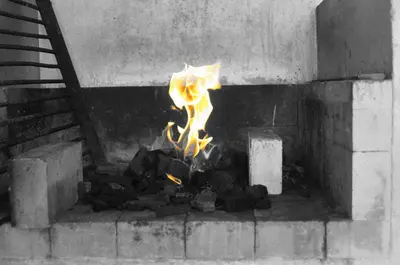 a fire in a brick oven with flames in it at Villa privada con hidromasaje Herradura Jaco in Herradura