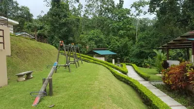 a playground in a garden with a hill at Villa privada con hidromasaje Herradura Jaco in Herradura