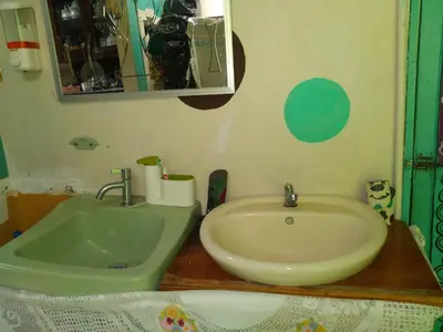 a bathroom with a sink and a mirror and a sink at Hostel Paco House in Monteverde Costa Rica